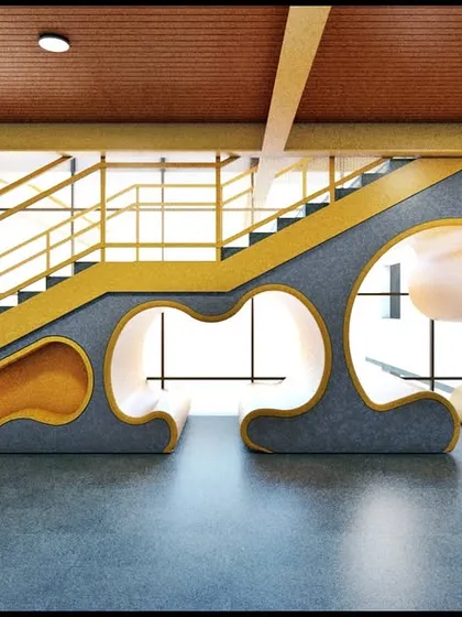 A design for the Birla School, featuring a playful and functional seating area integrated into the space under a staircase. The use of primary colors and organic shapes creates a stimulating environment for students.