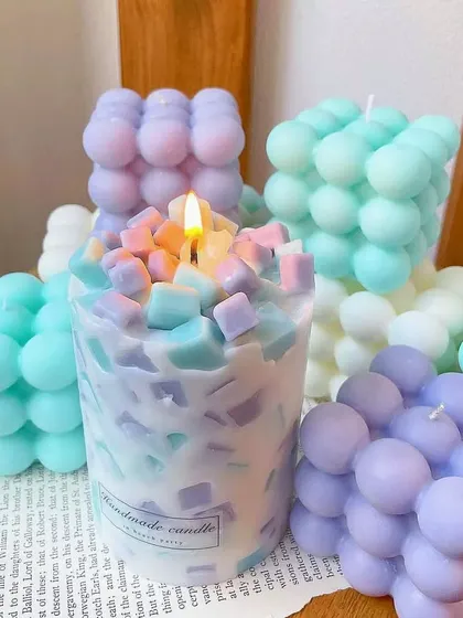 A playful collection of pastel-colored bubble candles and a unique chunk candle. These trendy designs are a fun way to decorate a shelf or desk.