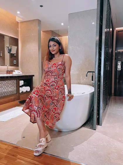 Posing in my hotel room before a wedding event. This patterned sundress with spaghetti straps is comfortable yet stylish for a destination wedding.