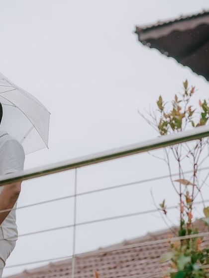 A wide shot of a couple during their outdoor baby shower, capturing the setting and atmosphere of the event.