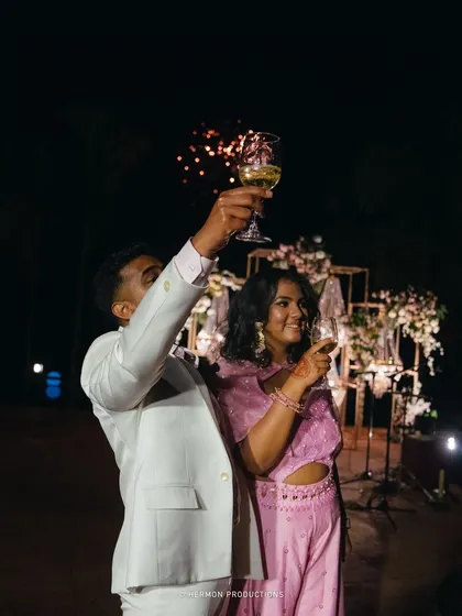 A toast to their future, with fireworks in the background. We planned this moment to create a spectacular end to the evening's formalities.