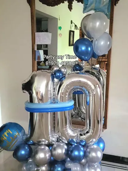 A 10th birthday balloon bouquet in blue and silver.