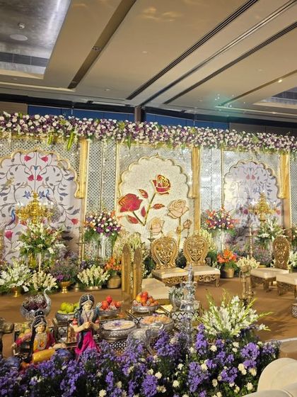 Another angle of the elegant stage, highlighting the traditional brass lamps and silver offering bowls.