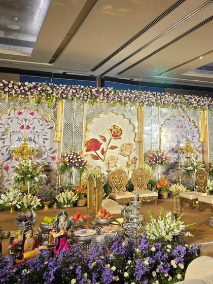 Another angle of the elegant stage, highlighting the traditional brass lamps and silver offering bowls.