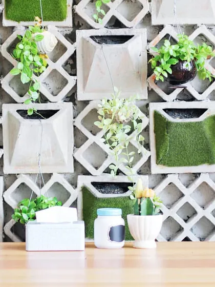 This modular wall combines concrete structural elements with pockets of green, including easy-to-care-for Pothos plants. It's a modern and stylish way to incorporate a vertical garden into an interior space.