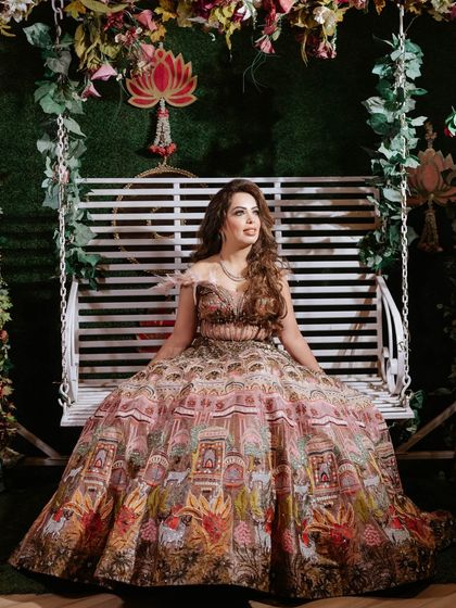 The full view of Nisha's unique printed lehenga. The makeup was kept glamorous yet balanced to let the outfit shine.