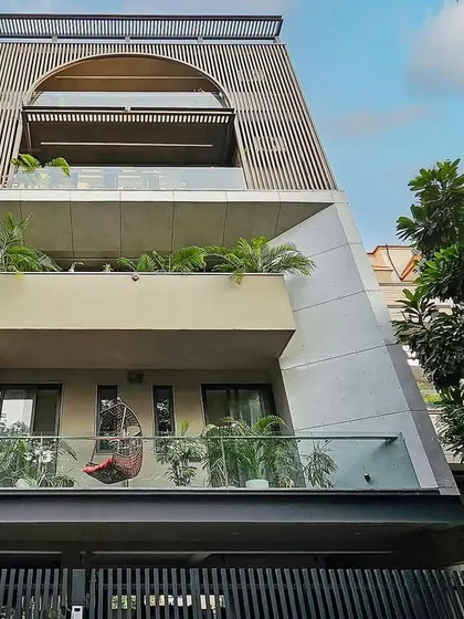 A view of the classical-meets-contemporary residence in Gurugram, where an arched form is framed by modern louvers. The design showcases how classical charm can be integrated into modern living.