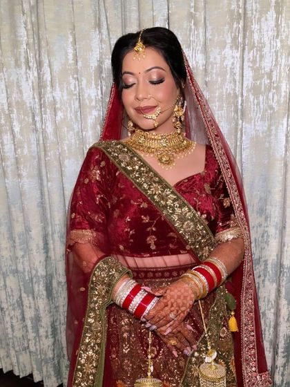 My beautiful friend and bride, Hitika. We went for a classic look with soft smokey eyes and a traditional red and gold lehenga.
