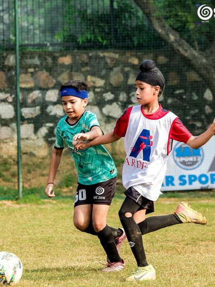 A GSC Blades player battles for the ball against a player from Ardee School in a U-11 match.