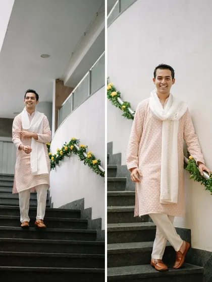 The groom posing by the staircase, which we decorated with simple yet elegant marigold garlands for the Haldi event.