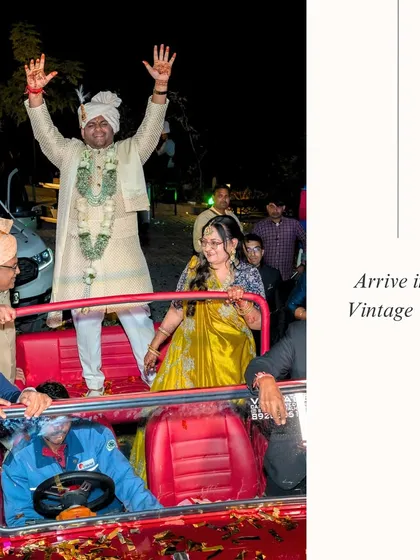 A jubilant groom's entry in a vintage red open-top jeep, perfect for a fun-loving and high-energy baraat.