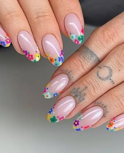 A delicate and beautiful Holi-inspired design. We created a French tip effect using tiny, multi-colored hand-painted flowers for a unique and artistic festive look.
