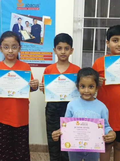 Students from different levels, from Junior to Foundation, proudly display their completion certificates. Progress at every stage is celebrated.