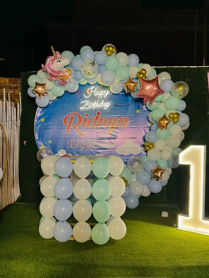 The magical unicorn birthday decoration set up at night, with the lights creating a beautiful effect.