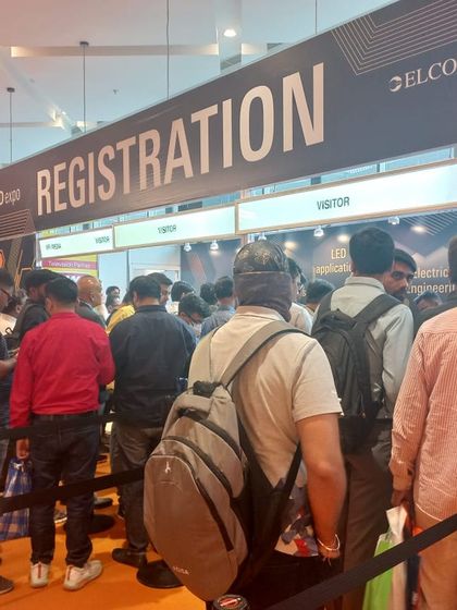 The registration desk is the first point of contact, bustling with attendees ready to start their expo journey.