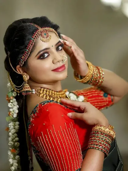 This model showcases a traditional look with a kasu malai set, complete with a matching vaddanam and jhumkas, perfect for a classic muhurtham.