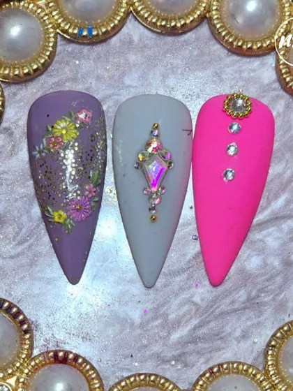A gorgeous trio of student designs, featuring delicate floral painting, precise stone placement, and bold color work.