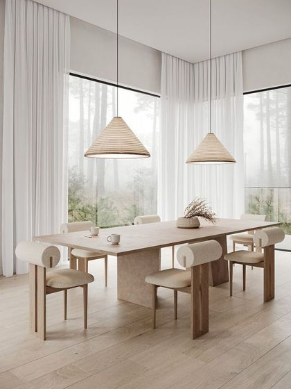 A minimalist and architectural dining set design. The long, clean lines of the wooden table are complemented by unique chairs with bolster-style backrests, perfect for a modern, serene dining room.