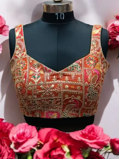 A well-crafted blouse can elevate your entire look. This designer blouse features intricate, multi-colored embroidery with peacock motifs, making it a versatile piece that can be paired with numerous sarees and lehengas. It’s a small piece of wearable art.