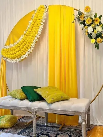 For this haldi ceremony, I used a modern gold ring frame decorated with traditional marigold garlands and bright yellow drapes. The comfortable bench seating makes it perfect for photos and for the main rituals.