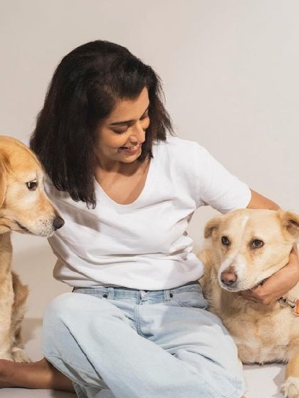 A beautiful moment between a woman and her two dogs. The love and happiness in this photo are so clear.