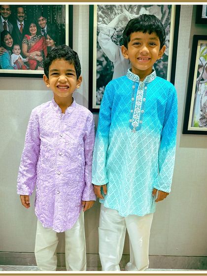Two brothers, perfectly coordinated in our lavender and ombre blue kurtas. It's a great example of our custom, stylish options for siblings.