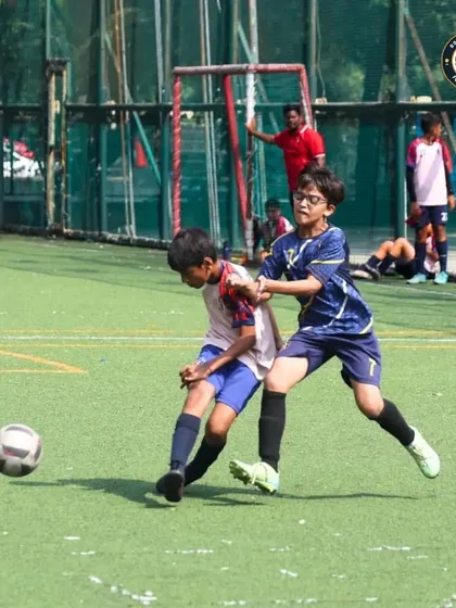 Fierce competition on the field during The Winter Cup. Our player battles for possession, showcasing the grit and determination we instill in every training session.