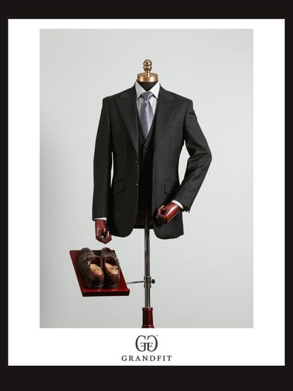 Displayed on a mannequin, the black three-piece suit's structure and drape are clearly visible, highlighting the quality of our tailoring.