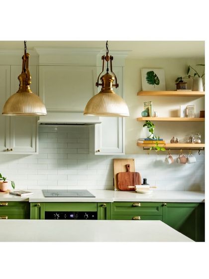 The kitchen at Casa 503 combines classic white and bold green cabinetry with beautiful brass pendant lights. It’s a functional space that is also full of style.