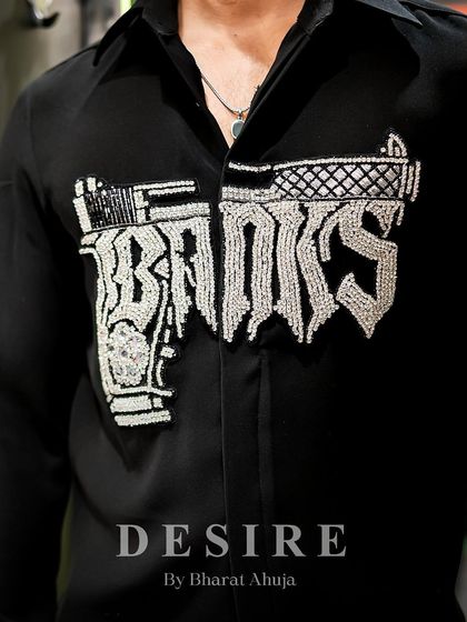 A close-up of the intricate beadwork on the 'Banks' gun shirt. Every detail is hand-stitched to create a piece of wearable art.