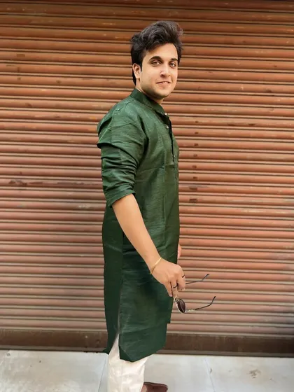 A posed shot in a green silk kurta from the Diwali Pahat 2022 festivities. This showcases a modern yet traditional look suitable for lifestyle and fashion brands.