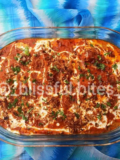 This is my signature Memon Malai Chicken. Unlike stove-top curries, I bake this dish to perfection. It has a rich red gravy base and is generously topped with malai (cream), fried onions, and fresh coriander, creating a wonderfully creamy and flavorful experience.