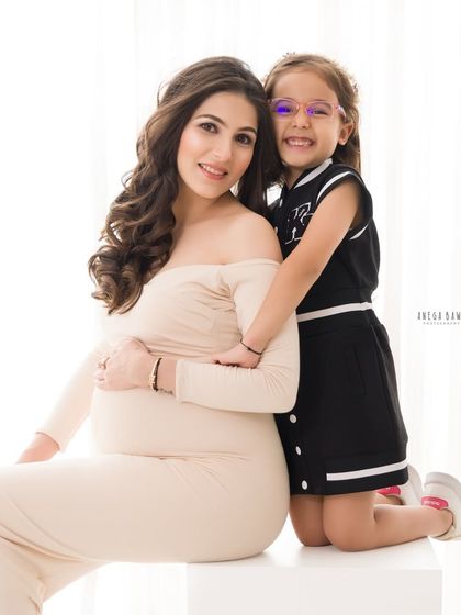 A sweet hug from behind, showing the close bond between a mother and her daughter during this special time of waiting.