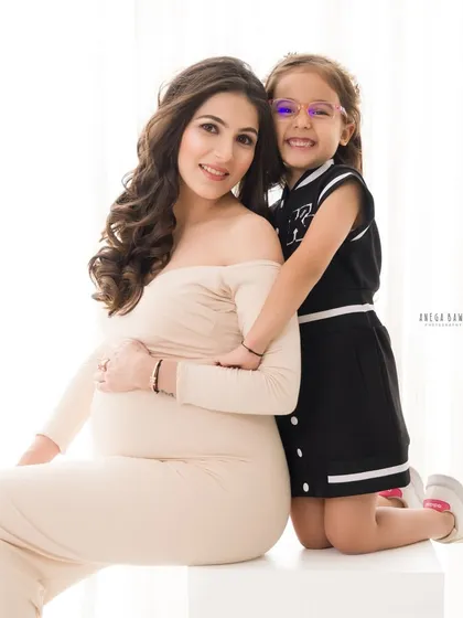 A proud big sister-to-be hugs her mom. I love to make older siblings feel special and involved during our maternity photoshoots.