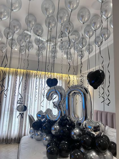 Another angle of the 30th birthday setup, highlighting the density of the ceiling balloons and the way the entire arrangement transforms the room for a surprise celebration.