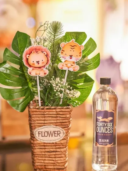It's all in the details. Even the table centerpieces are themed, like this one with cute lion and tiger cutouts nestled in a floral arrangement.