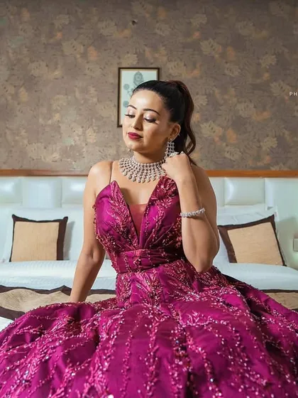 An elegant portrait of the bride looking down, highlighting the details of her gown and jewelry before her engagement party.