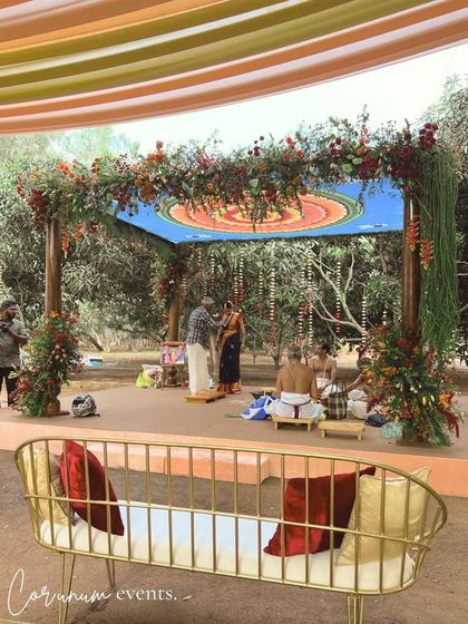 A view of the backyard mandap from the guest seating, showing how the structure integrates beautifully into the natural environment.