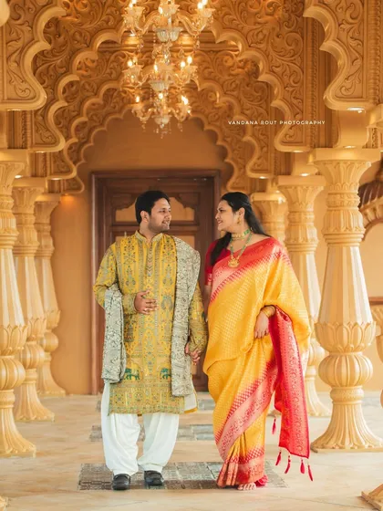 Dressed in elegant ethnic wear, this couple's pre-wedding shoot at a heritage location combines tradition with grandeur. The intricate architecture provides a timeless backdrop for their portraits.