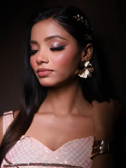 A glamorous look for the season. This photo from a creative shoot features shimmery eyes, a winged liner, and a soft, glowing complexion.