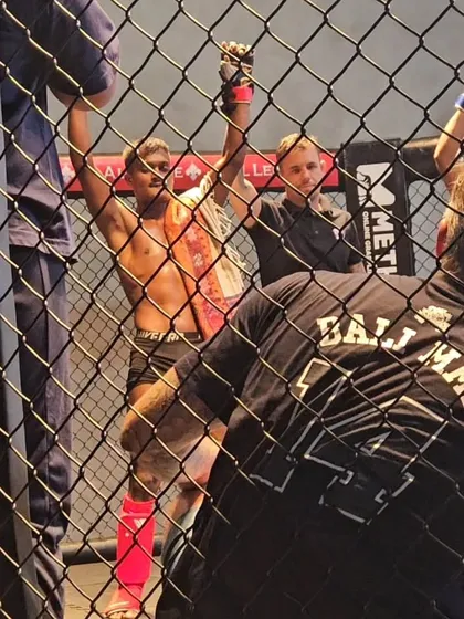 A fighter celebrates his victory inside the cage at Bali MMA.