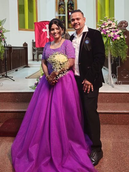 A beautiful couple inside a church for their engagement ceremony. The bride-to-be is wearing a stunning purple ball gown.