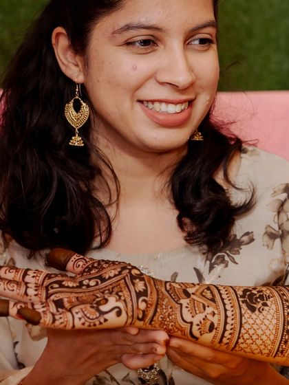 Another happy client, smiling as she shows off her completed bridal henna.