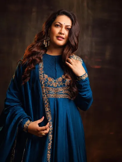 A full-length view of the flowing teal Anarkali.