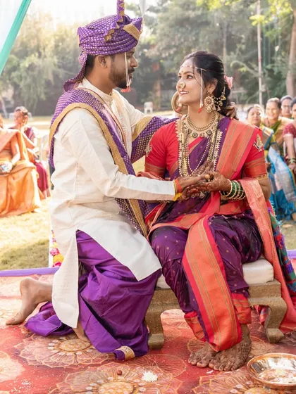 A candid moment from a traditional Maharashtrian wedding ceremony. The bride's makeup is designed to look fresh and radiant even in the bright, outdoor light.