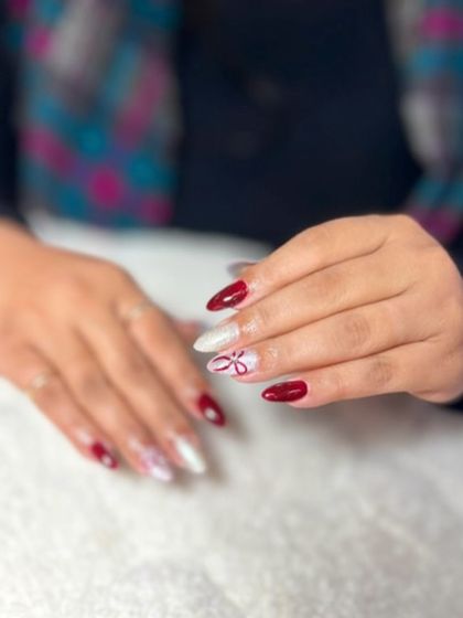 A festive combination of red, white, and glitter with a delicate floral design. This shows how to balance multiple colors and finishes in one set.