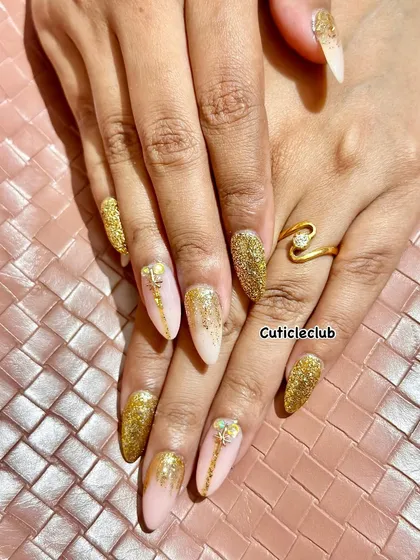 Nothing says celebration like a full set of gold glitter nails. This glamorous look uses a combination of fine and chunky glitter for maximum sparkle, perfect for a wedding reception, sangeet, or any festive party.