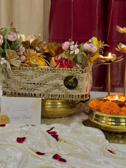 This is where the magic of Diwali comes alive in my 'Rang & Noor' collection. I've combined a beautiful floral arrangement with traditional diyas and gourmet treats in a handcrafted basket, creating the perfect festive gift.