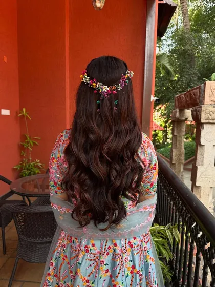 A full back view of the Haldi hairstyle, showing the length of the waves and the beautiful heart shape of the floral crown.