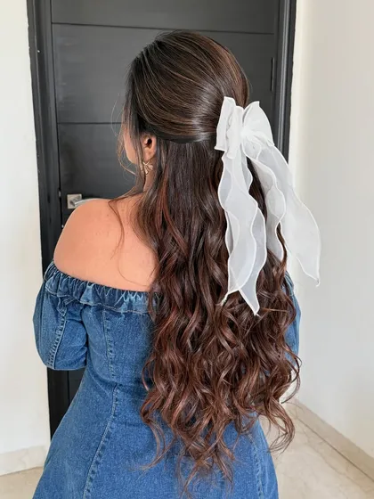 Another angle of the soft, half-up hairstyle with the white organza bow. It's a dreamy and romantic look.